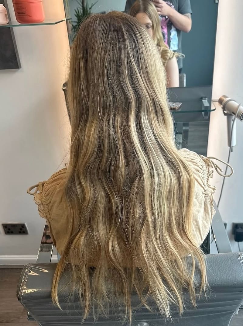 Before: long blonde hair with warm, grown-out roots and uneven tone.