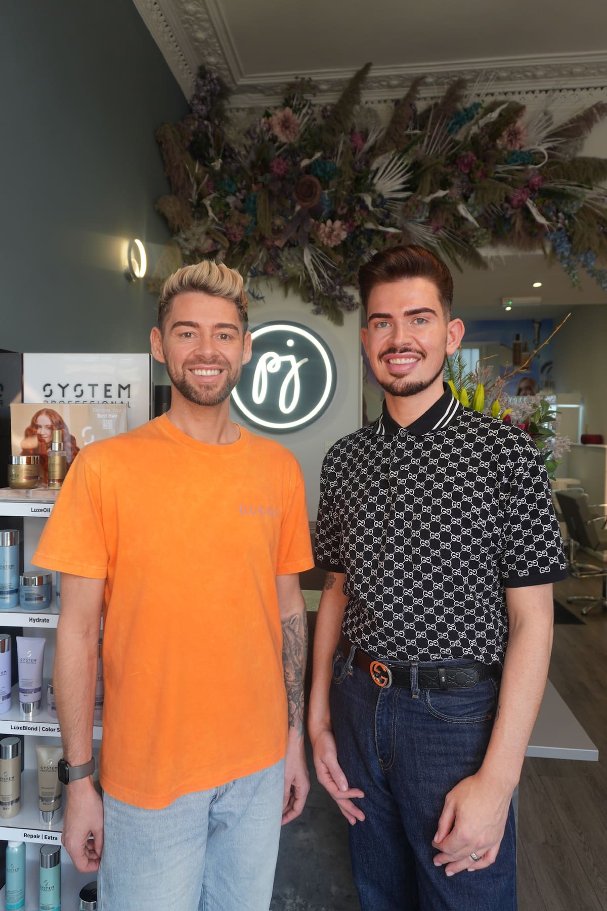 James, left, and Peter, right, standing together in the salon.