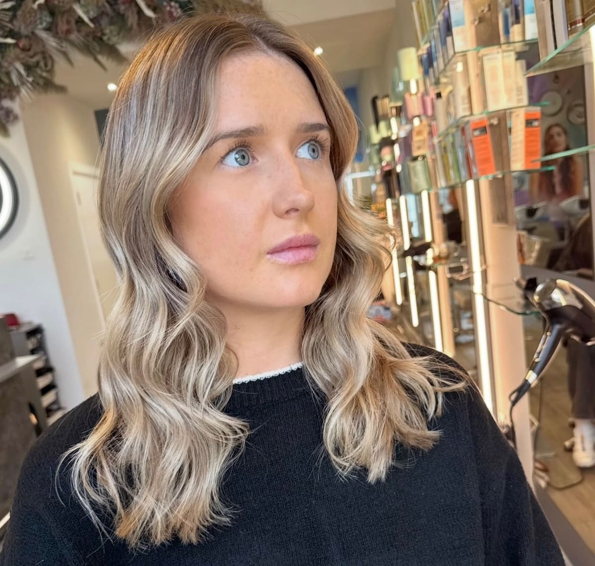 Mid-length blonde with a soft wave.