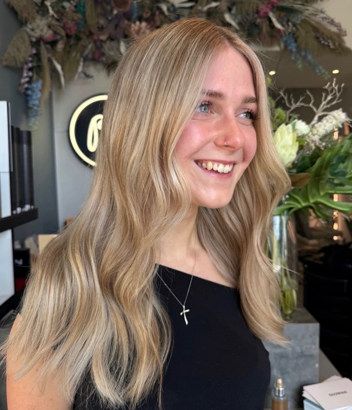 Soft blonde waves, mid-length.