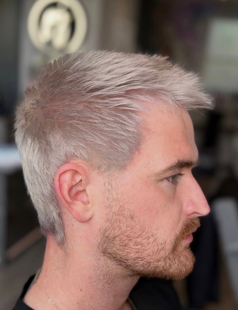 A men’s short cut, bleached to pale platinum.