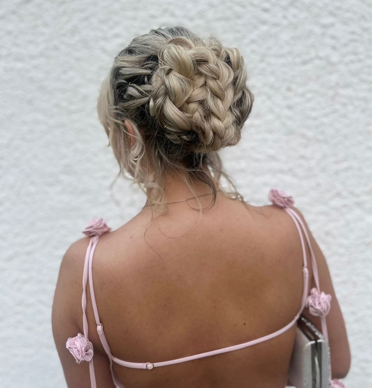A plaited up-do pinned at the back of the head.