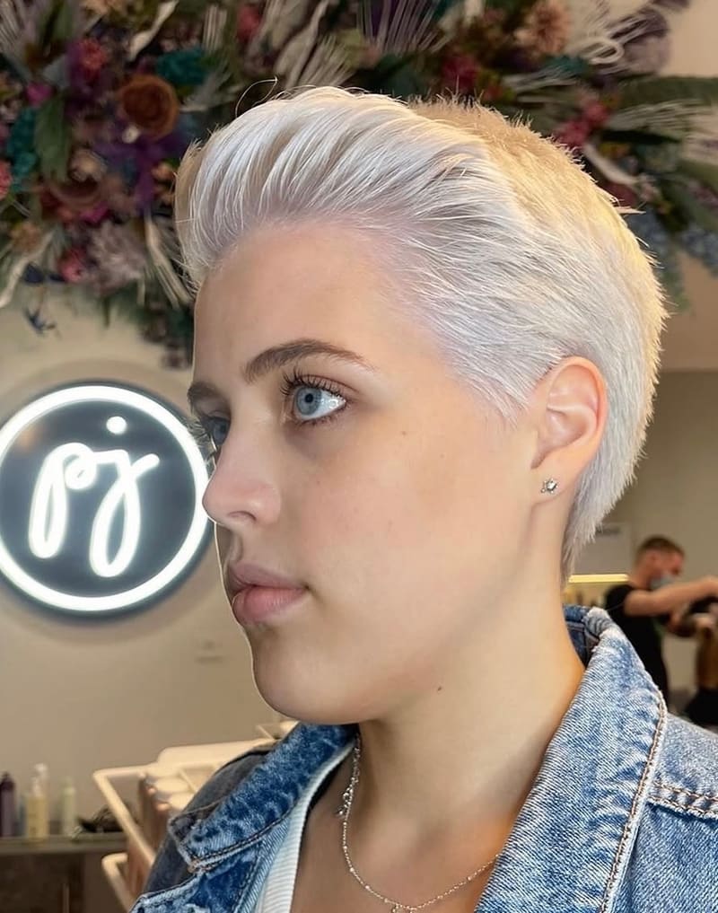 A platinum pixie cut, swept back.