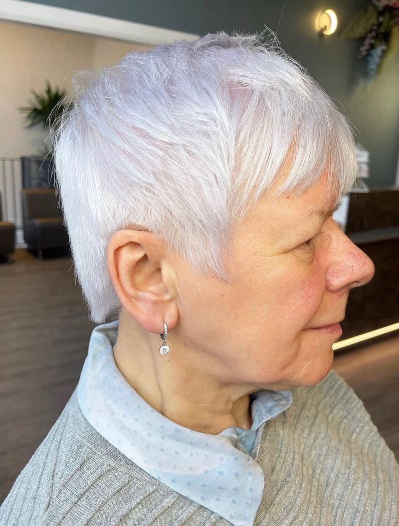 Full head bleach and tone: a short silver-white pixie, shaped around the ear.